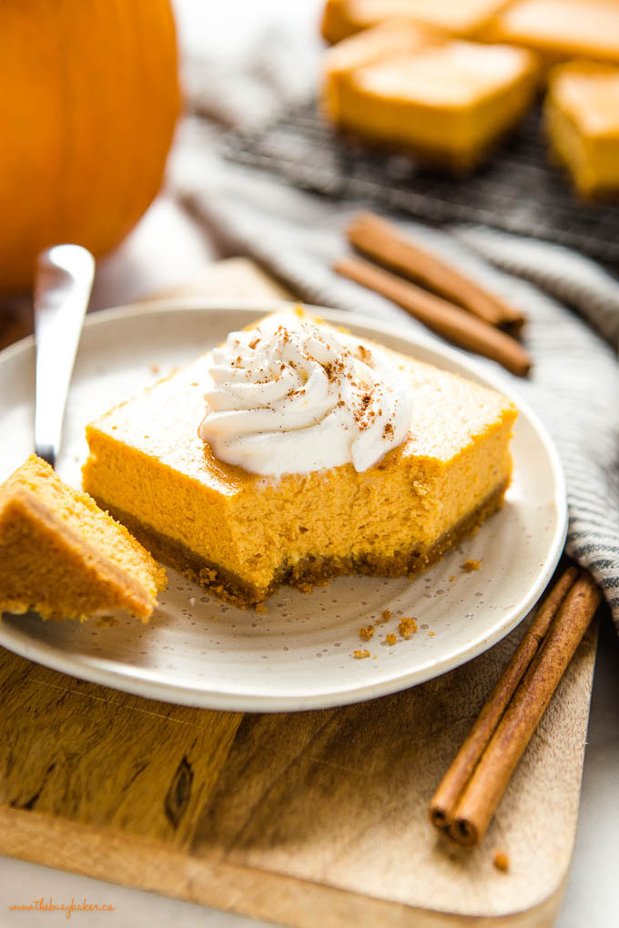 bite of pumpkin cheesecake bar on plate with fork