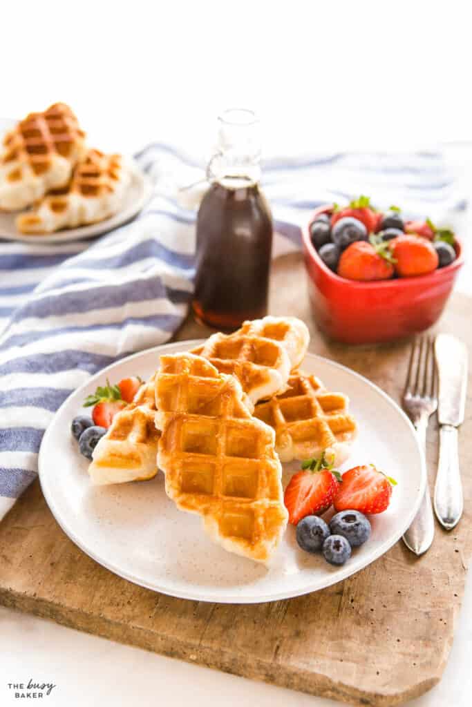 croissant waffles on white plate with fruit