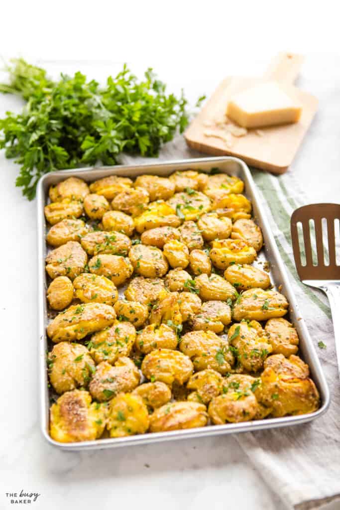 sheet pan of roasted potatoes with parmesan and herbs
