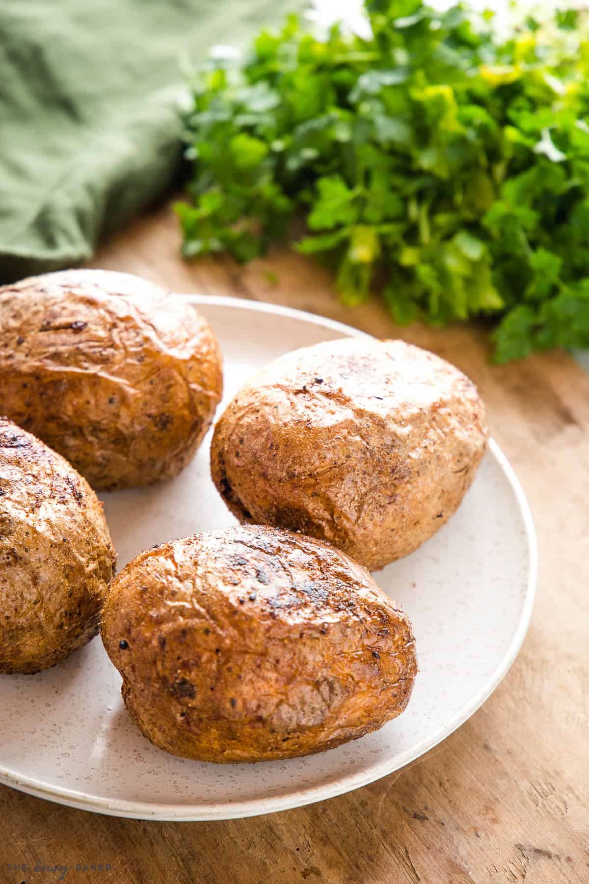 4 air fryer baked potatoes on a plate