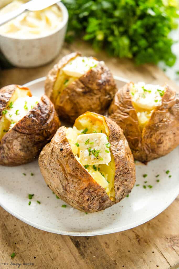 air fryer baked potato with butter, chives, sea salt, and pepper
