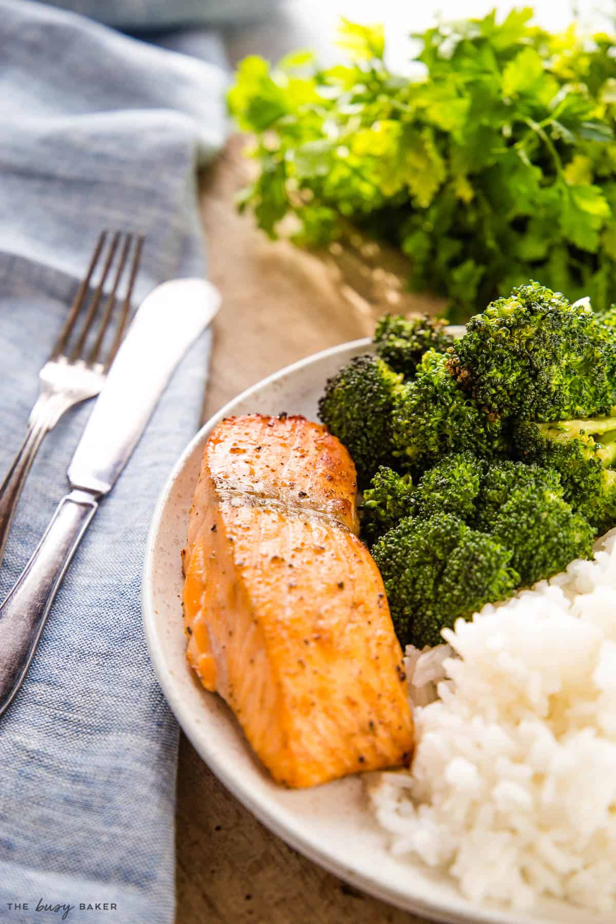 air fryer salmon fillet on plate with rice and broccoli