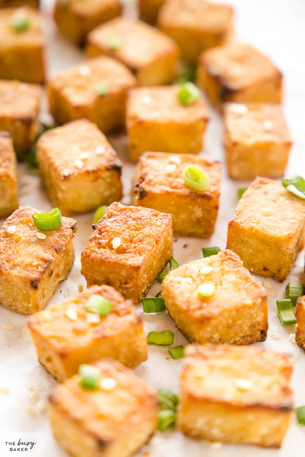 closeup image: crispy tofu with sesame seeds and green onions