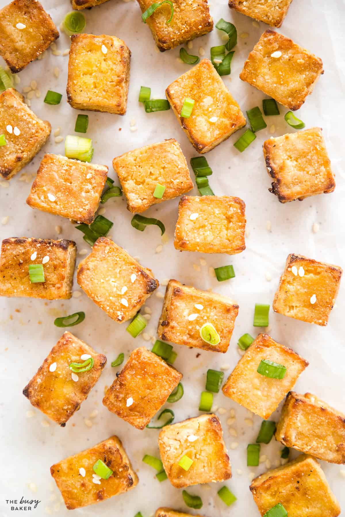 overhead image: crispy tofu with green onions and sesame seeds