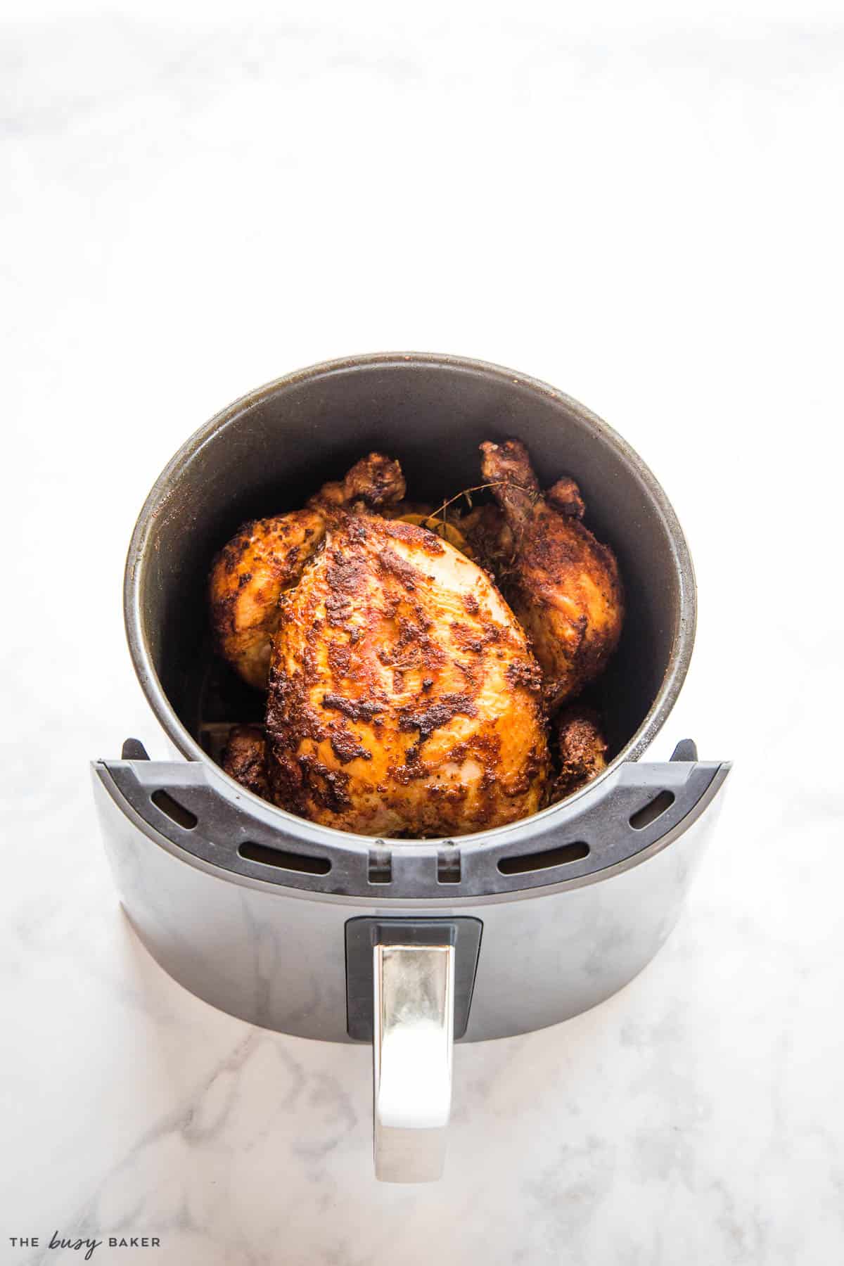 roasted whole chicken in the air fryer bucket