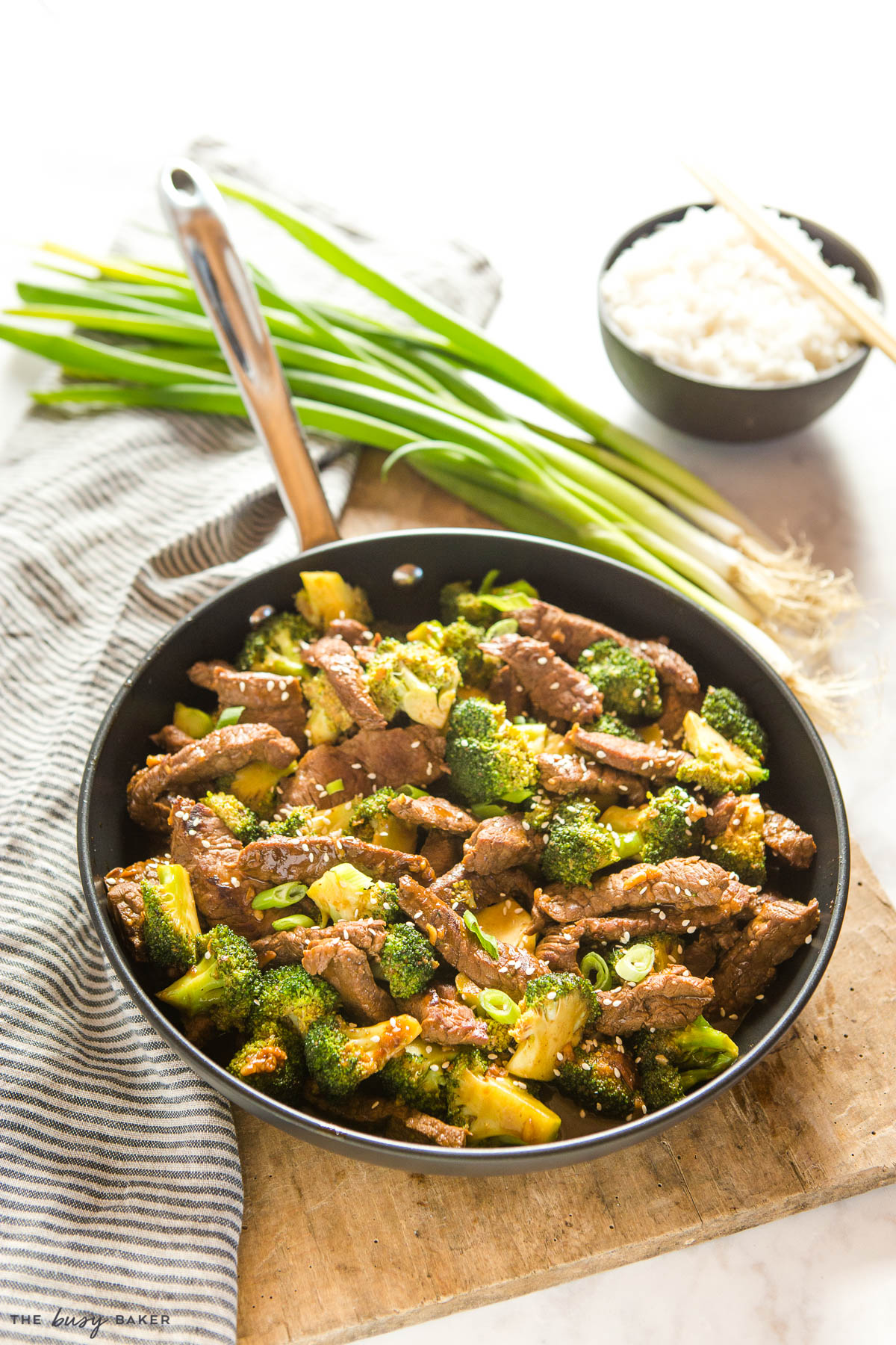 beef and broccoli stir fry in black frying pan