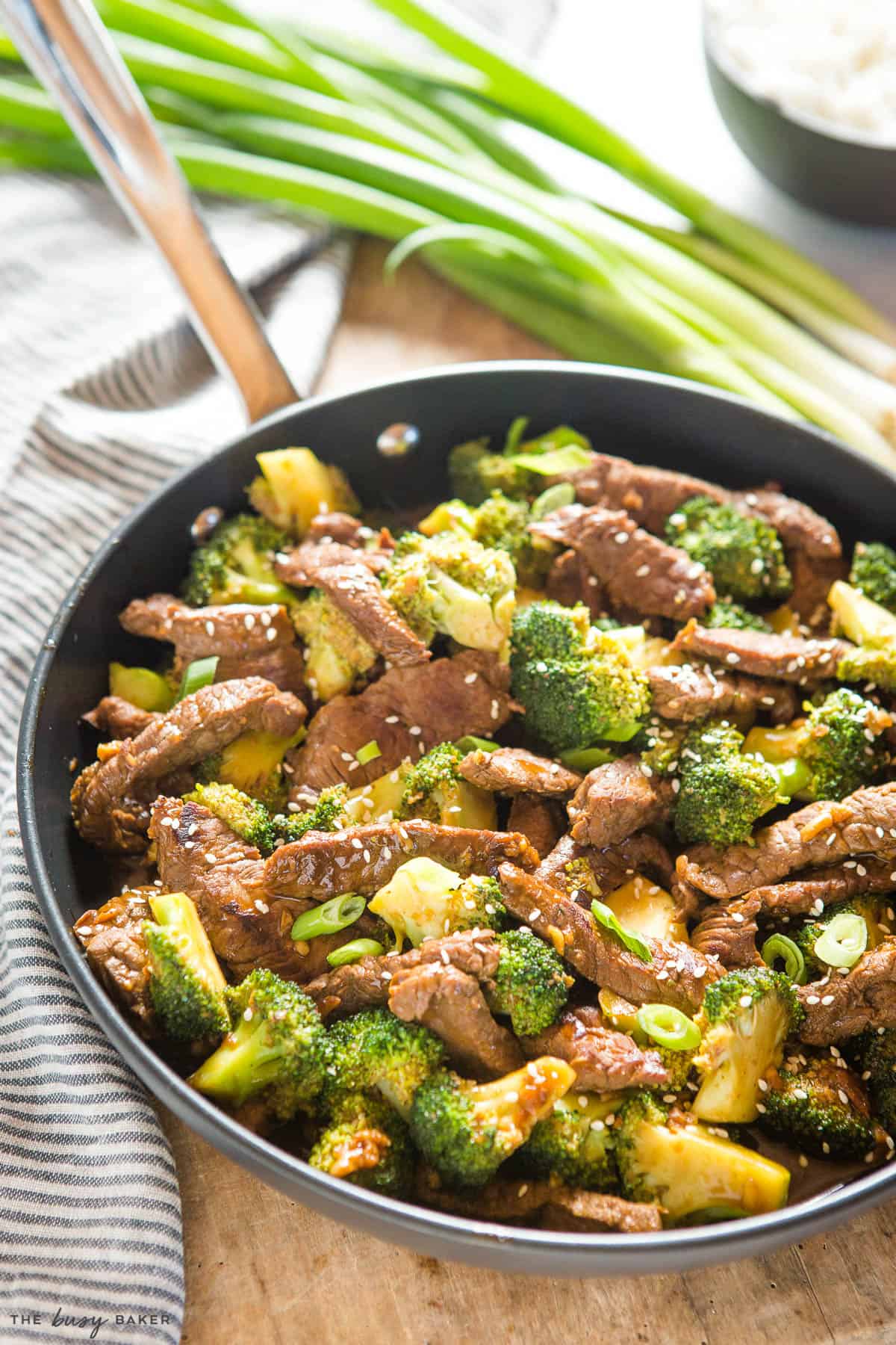 beef and broccoli stir fry in black frying pan