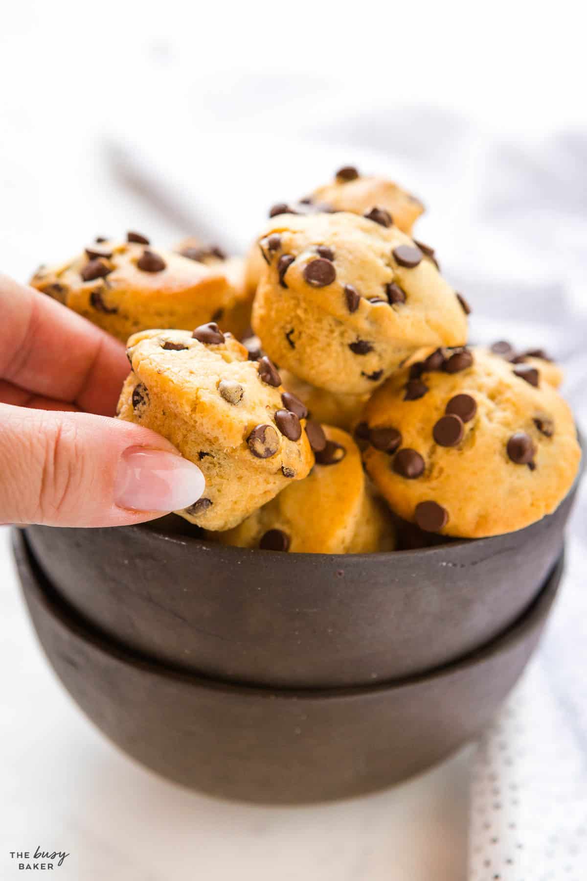 hand reaching for mini muffin with chocolate chips