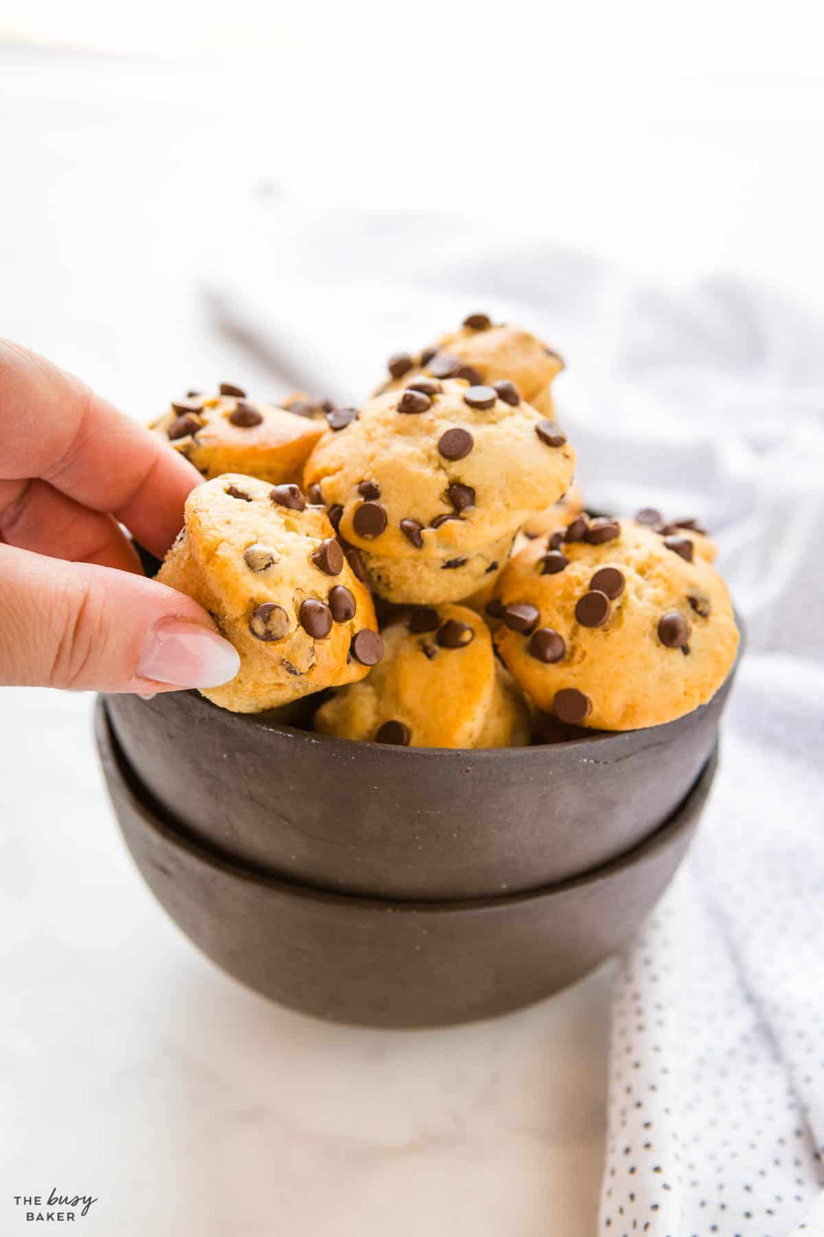 hand reaching for mini muffins with chocolate chips