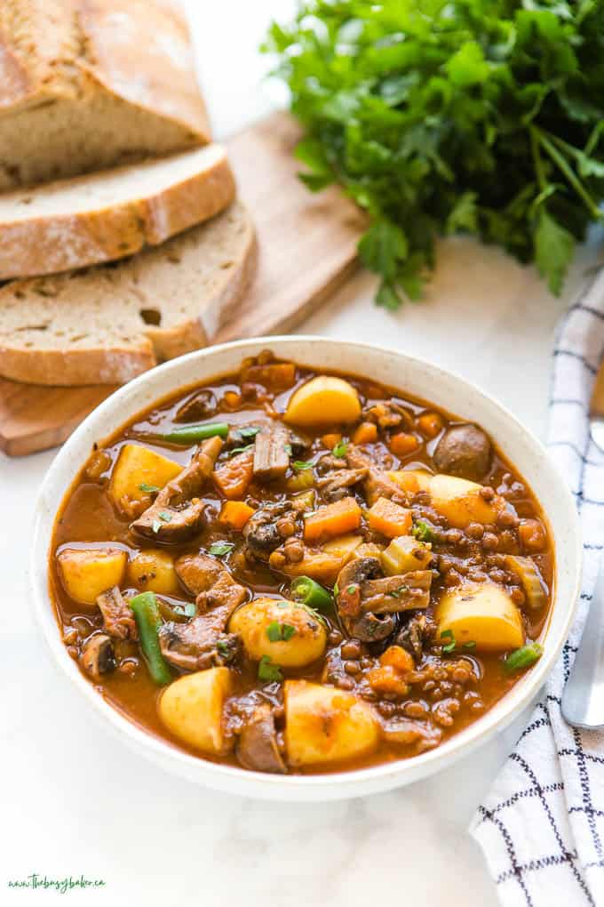 bowl of vegetable stew with bread 