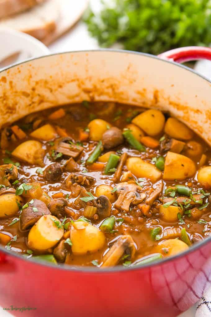 closeup image: vegetable stew with potatoes, carrots, mushrooms, lentils, and green beans