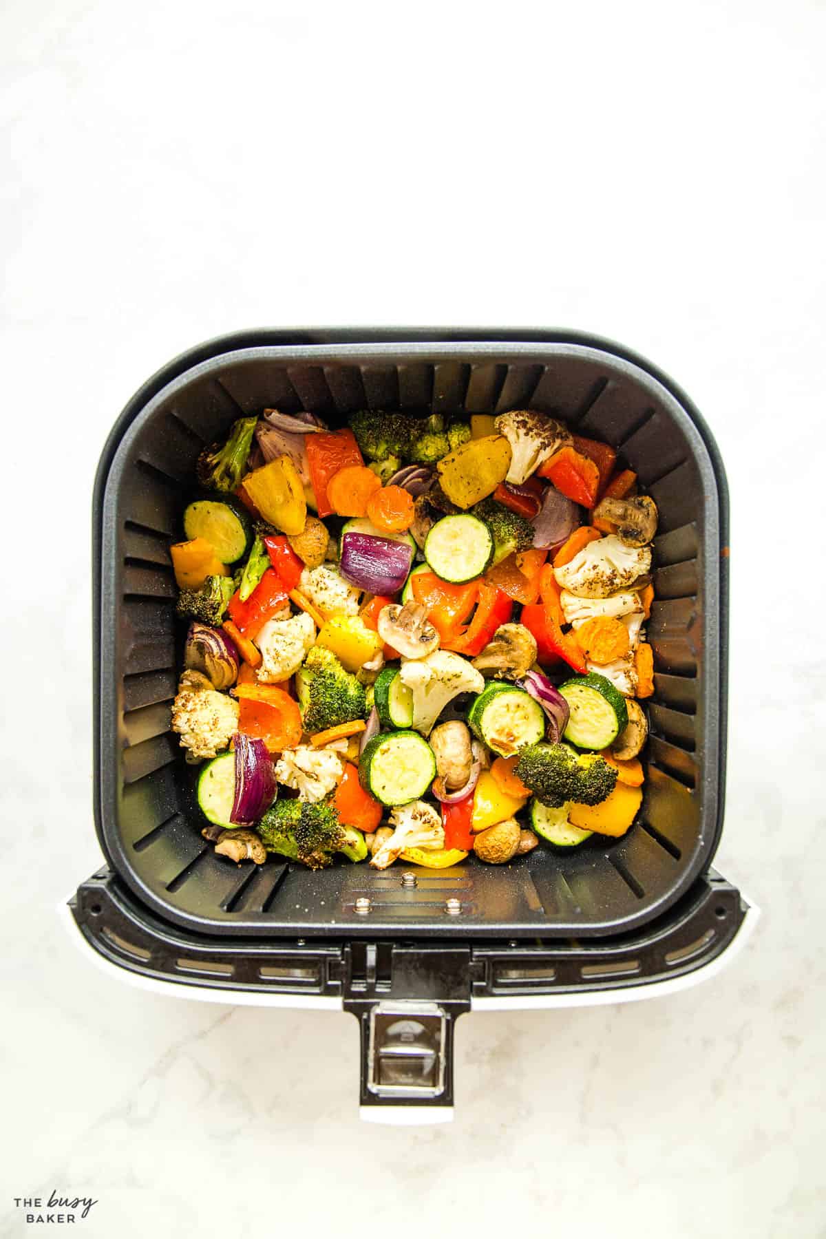 overhead image: roasted vegetables in air fryer basket