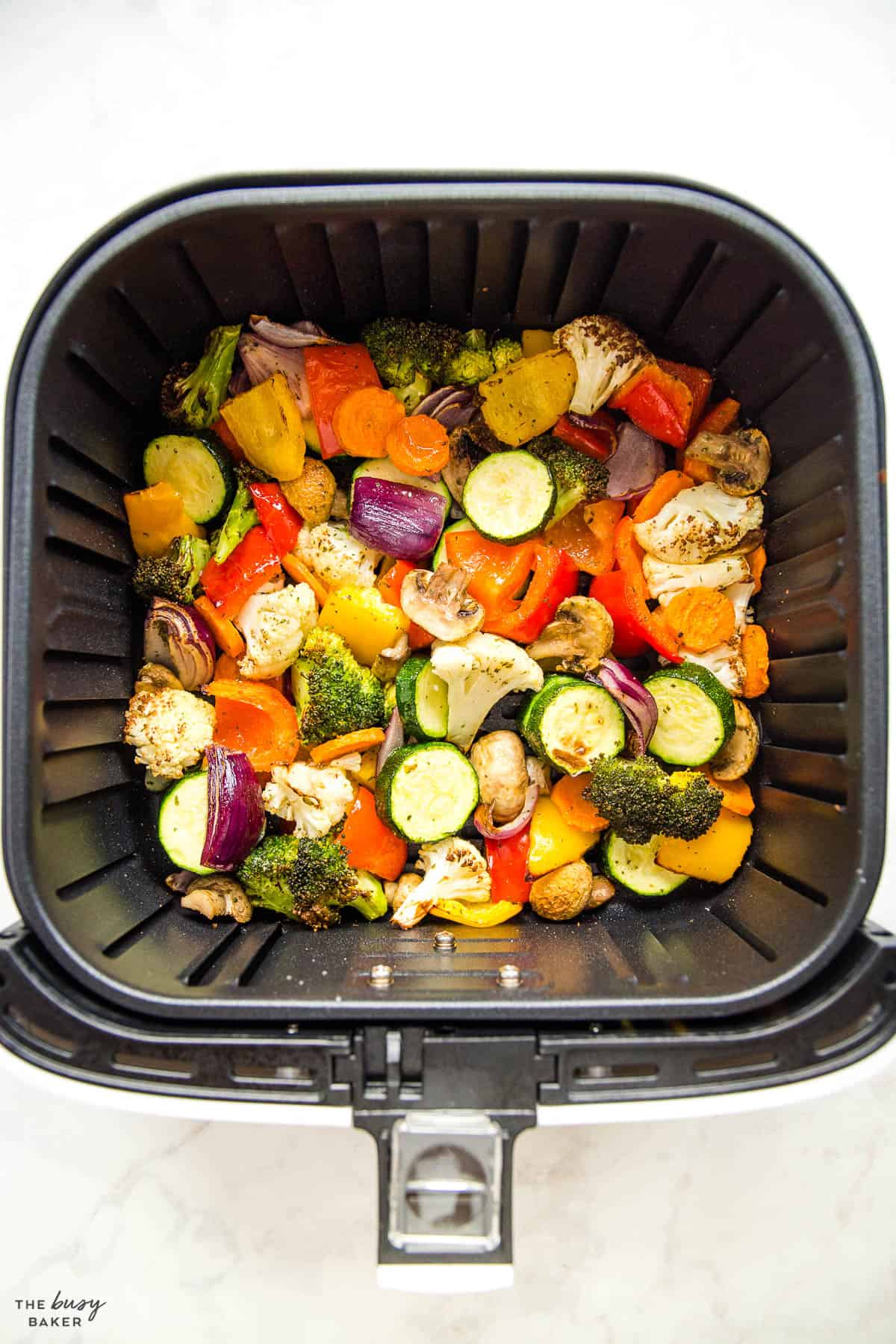 overhead image: roasted vegetables in air fryer basket