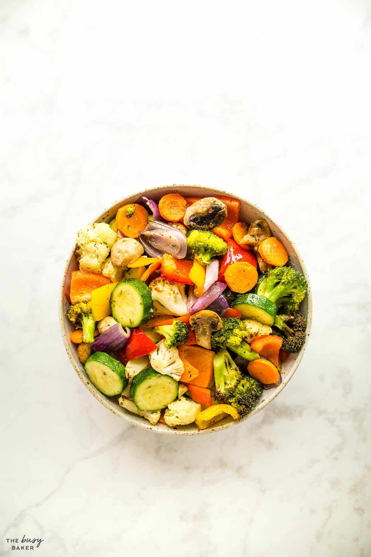 overhead image: roasted vegetables in a ceramic bowl