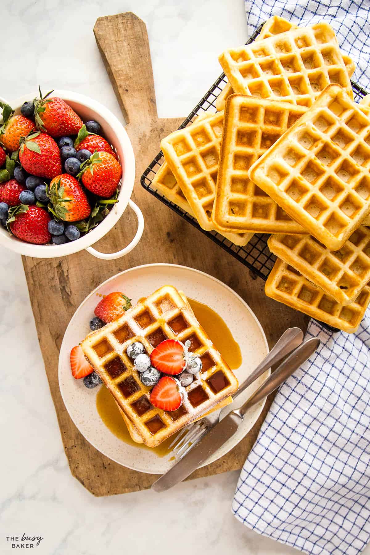 overhead image: breakfast table with waffles, fruit, and maple syrup