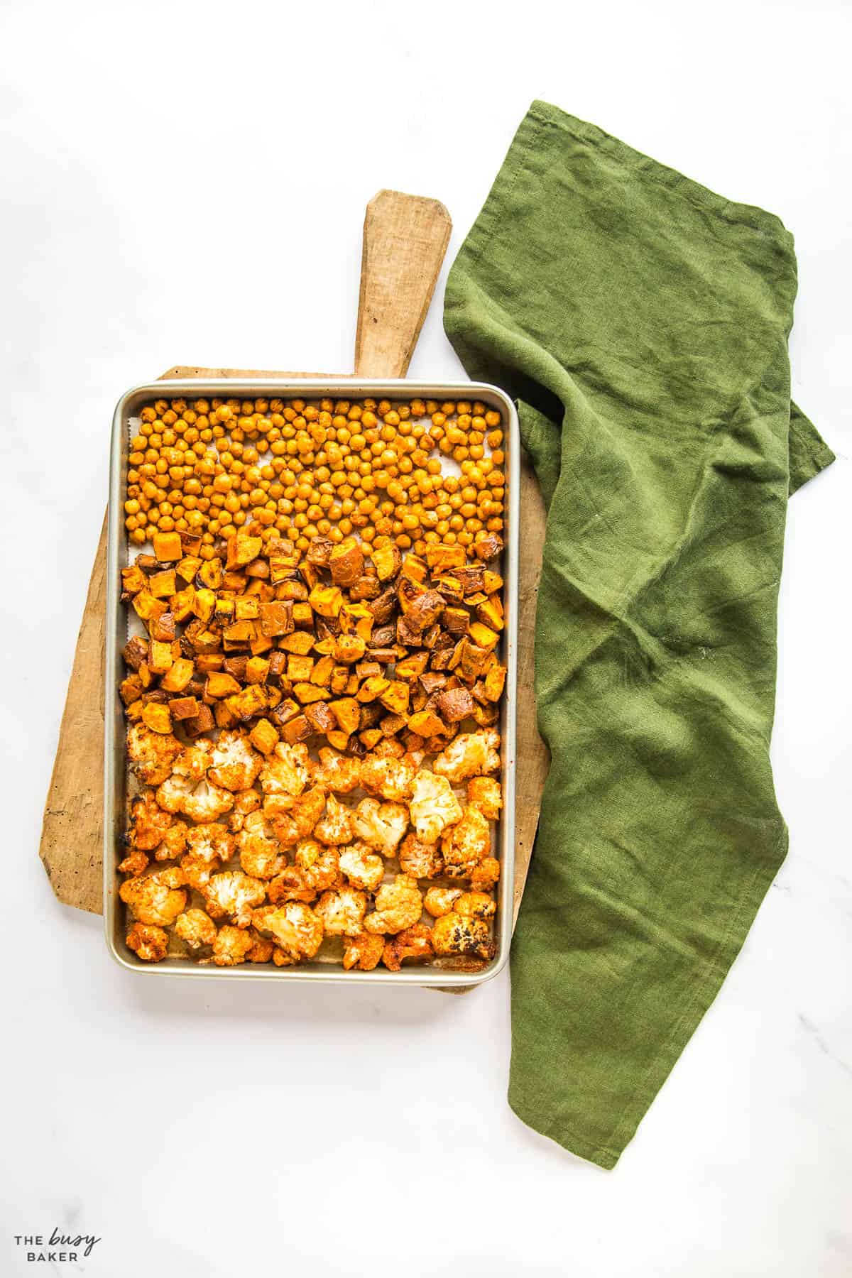 sheet pan with roasted chickpeas, sweet potatoes, and cauliflower