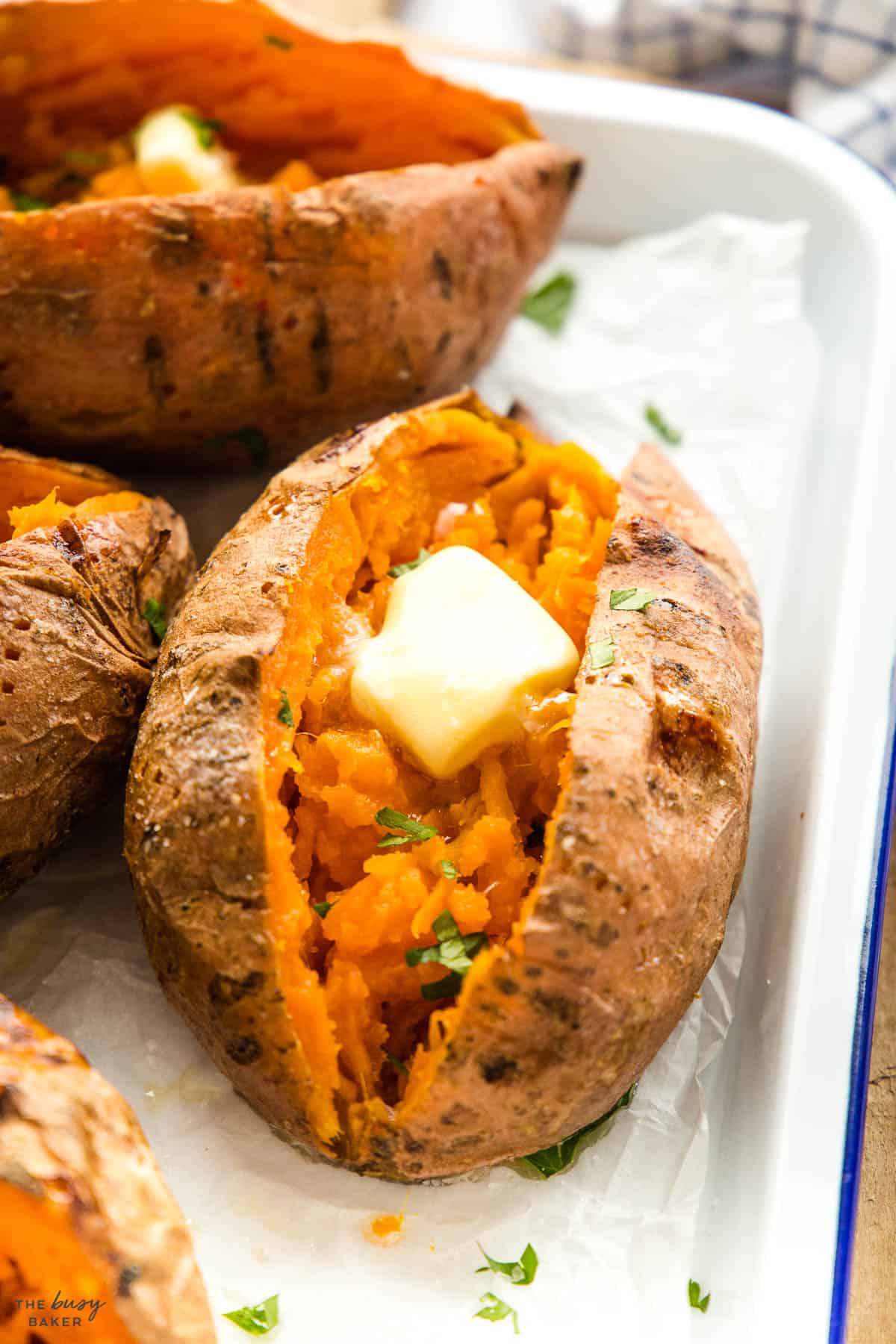 closeup image: baked sweet potato with butter and parsley