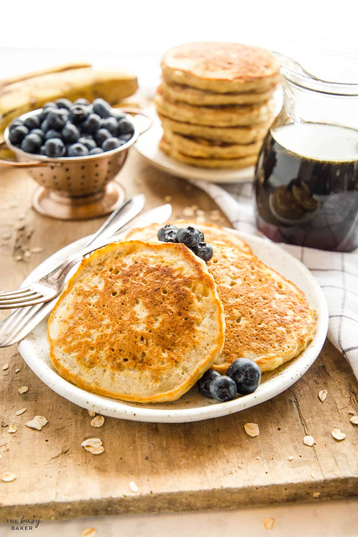 banana pakcakes on a plate with blueberries