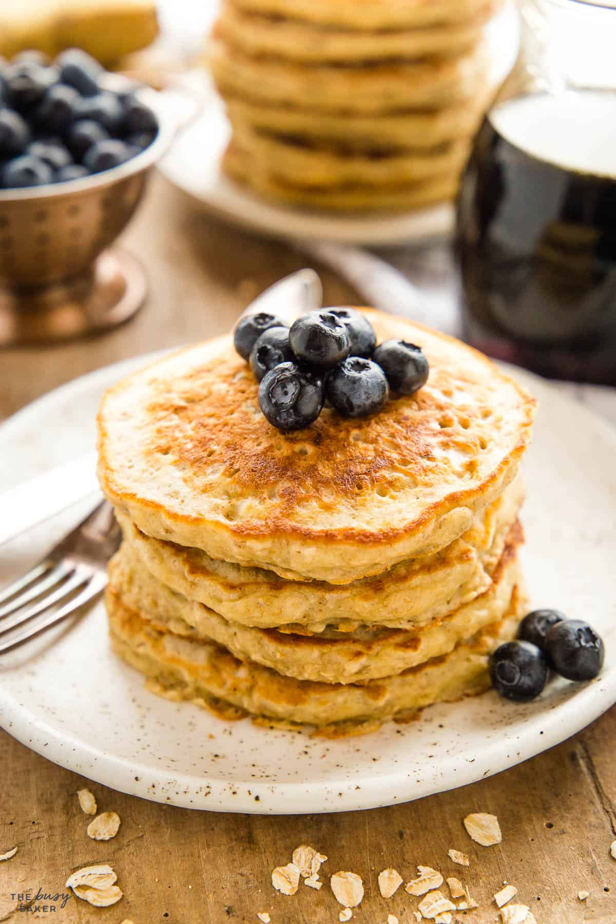 stack of golden brown pancakes with blueberries