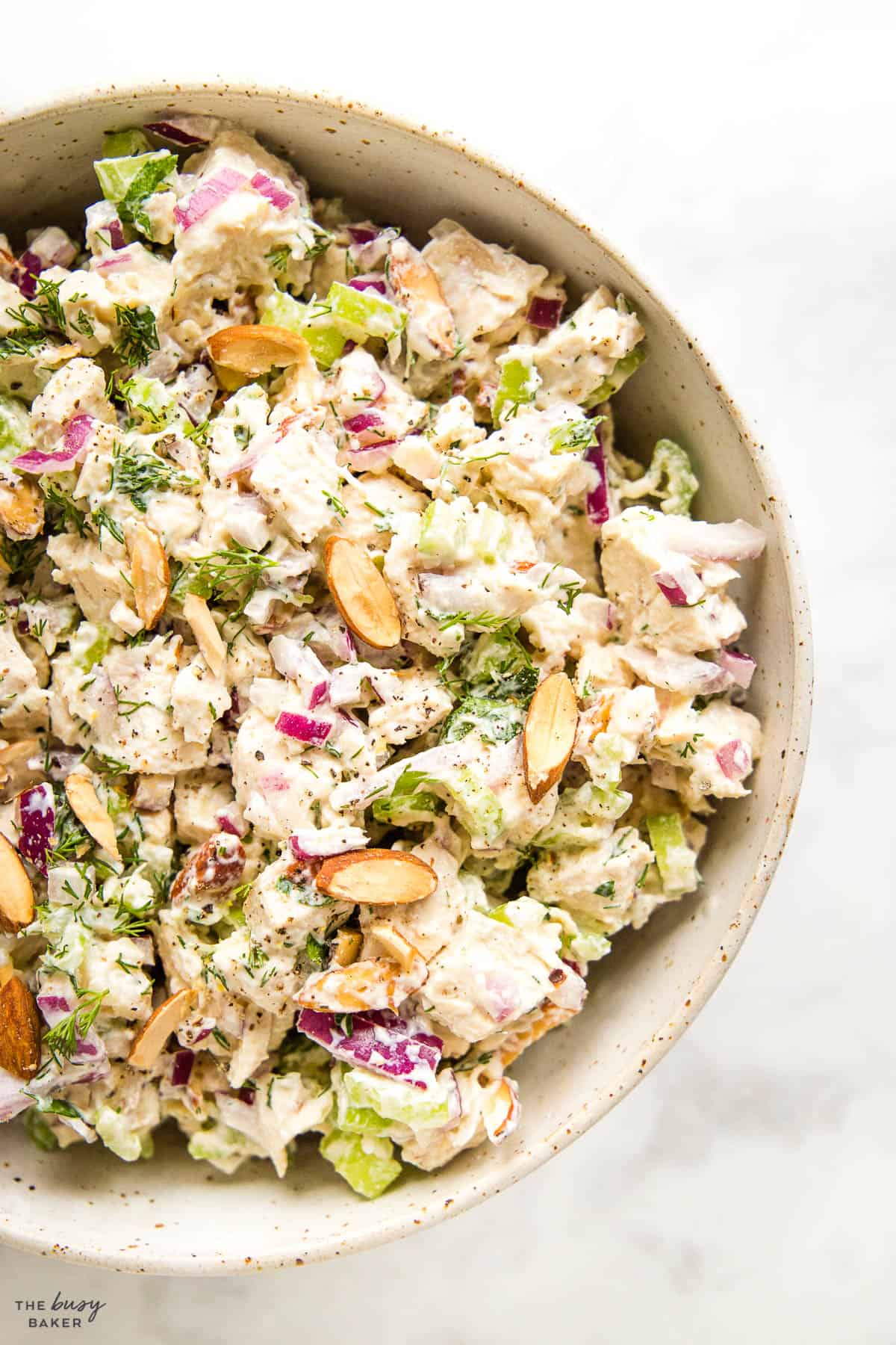 creamy salad with chicken, celery, onions, and almonds