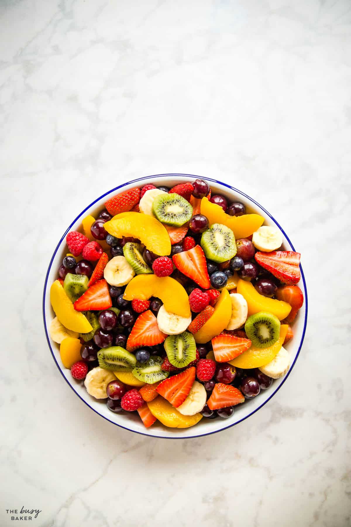 overhead image: a mixture of fruits in a bowl