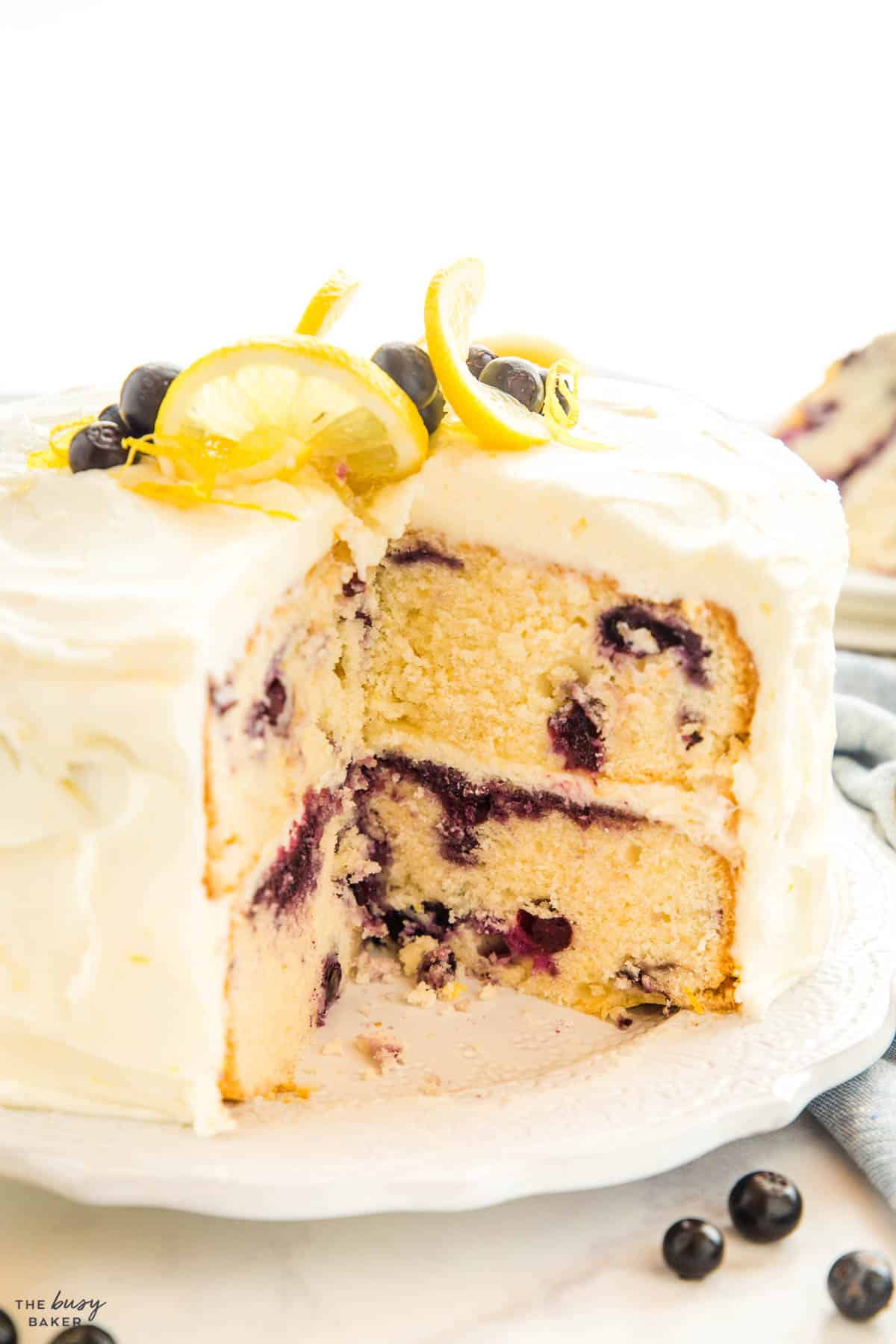 layer cake with citrus frosting and berries