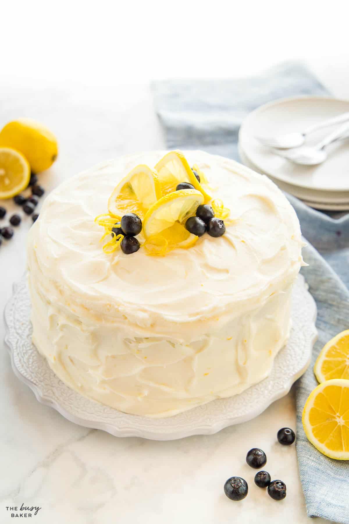 layer cake with citrus frosting and berries