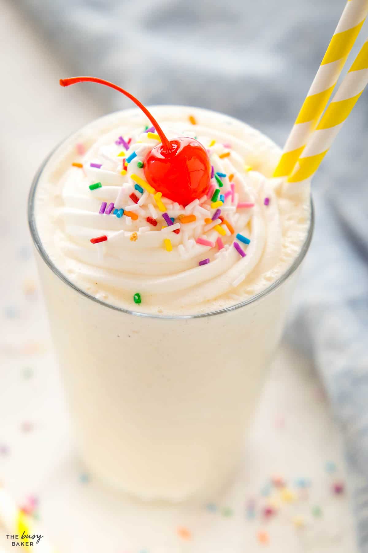 ice cream drink with whipped cream, sprinkles and a cherry