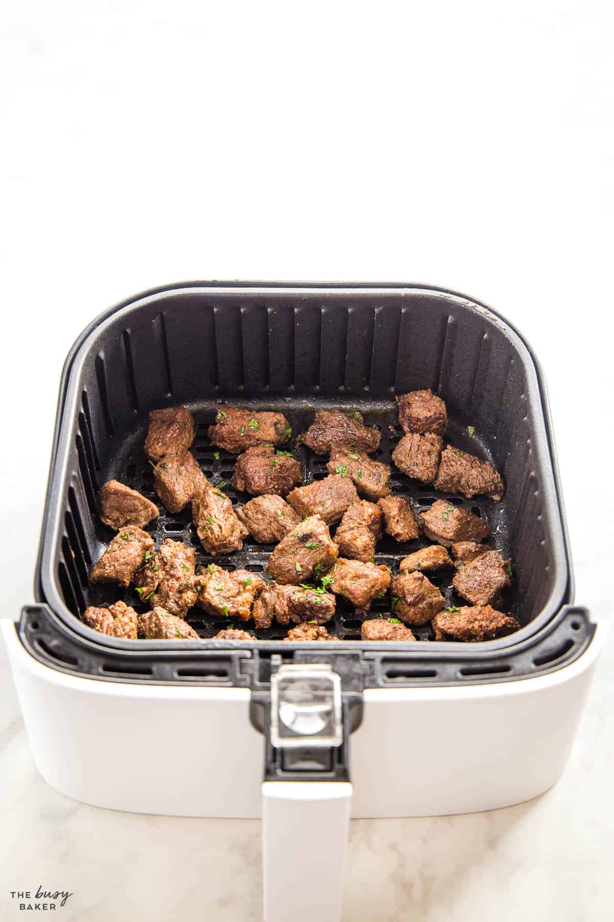 steak pieces in air fryer basket
