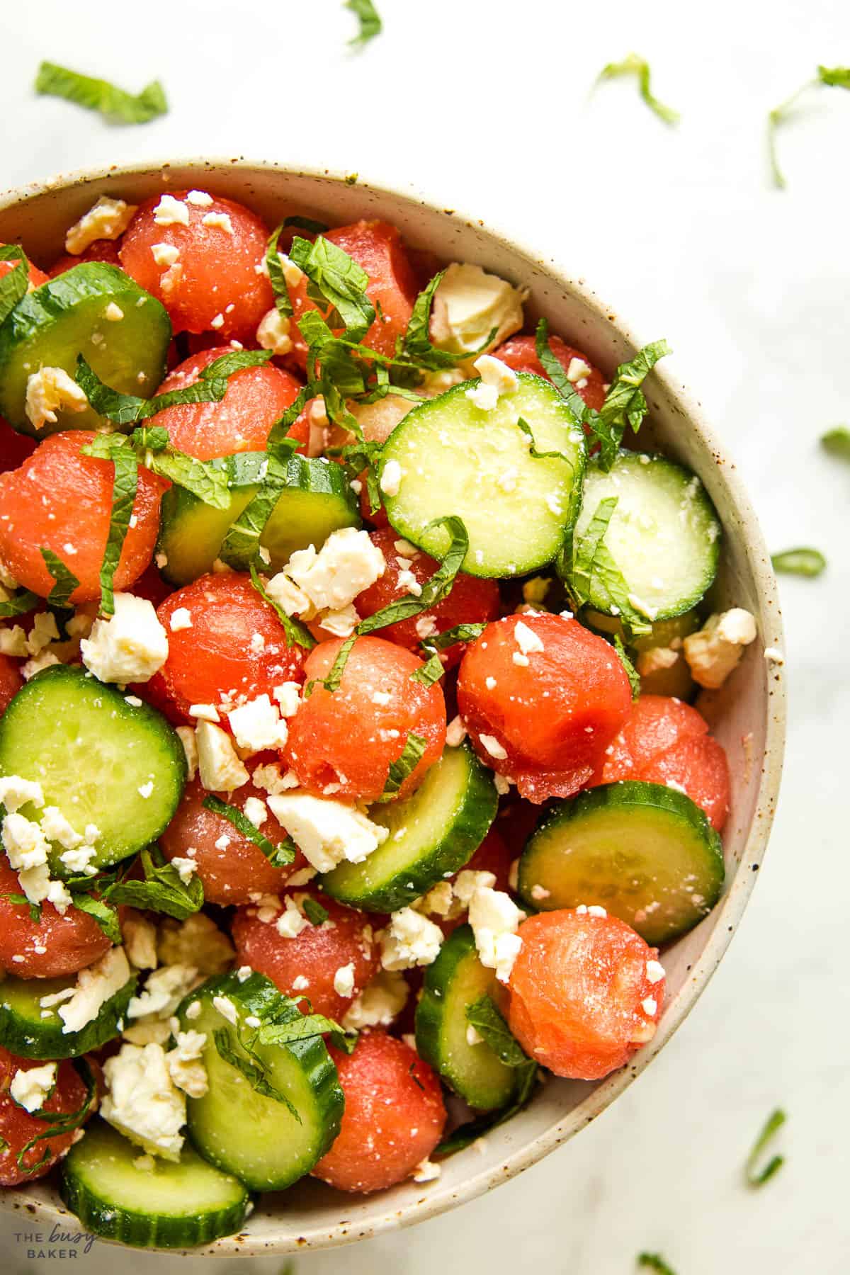 overhead image: melon salad with cucumber, mint, and feta