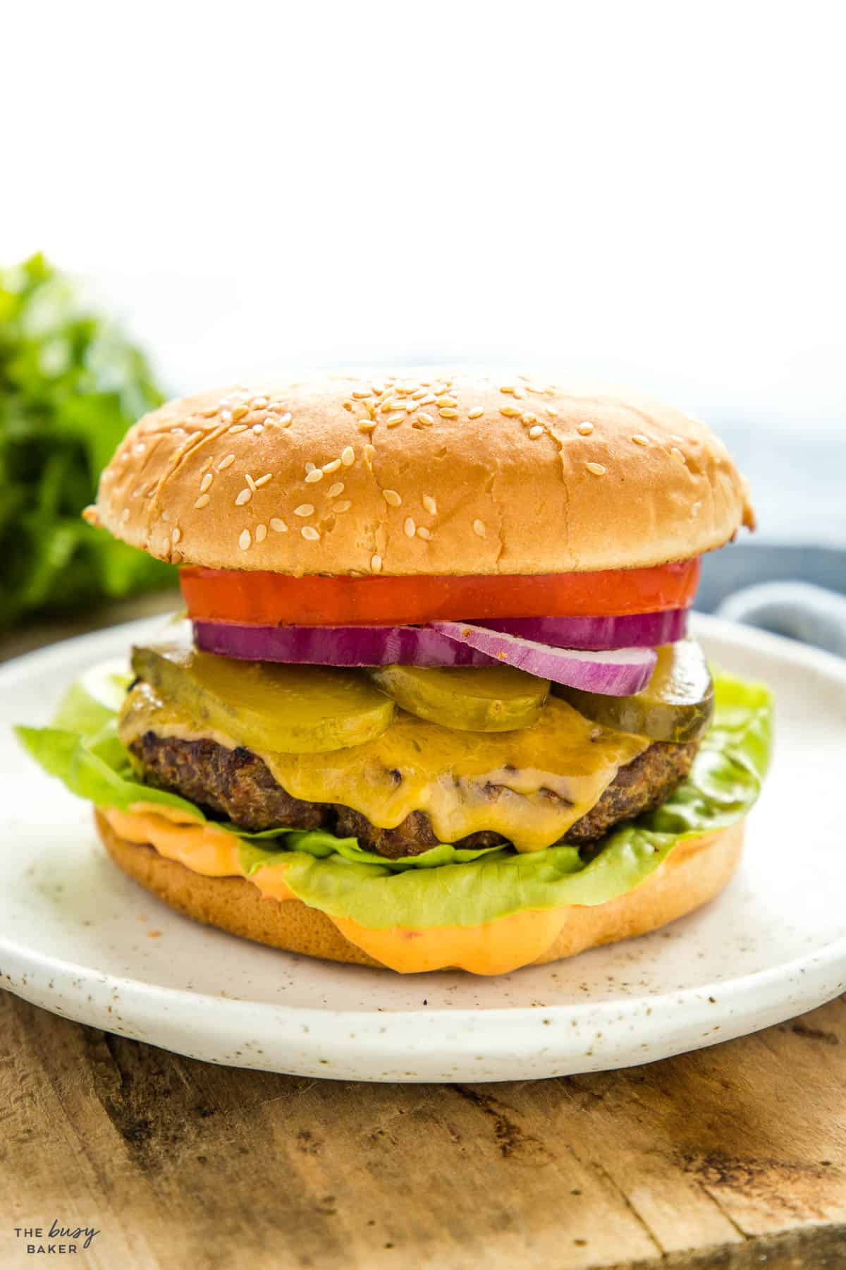 closeup image: burger on a sesame seed bun