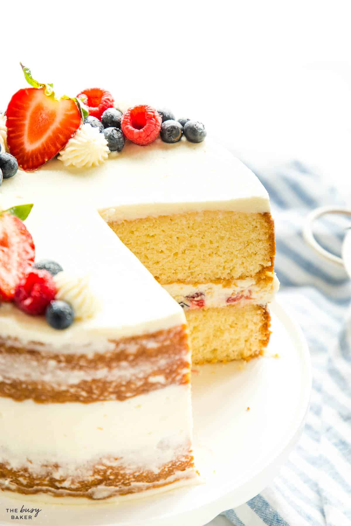 white layer cake with berries and chantilly cream
