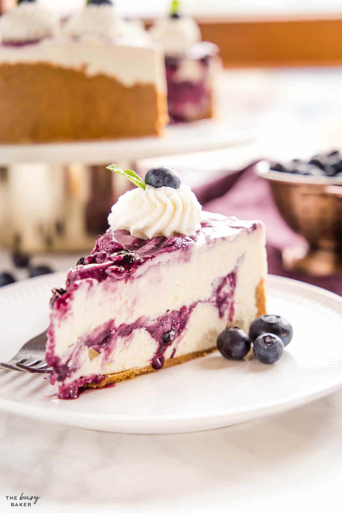 slice of no bake cheesecake with blueberry sauce