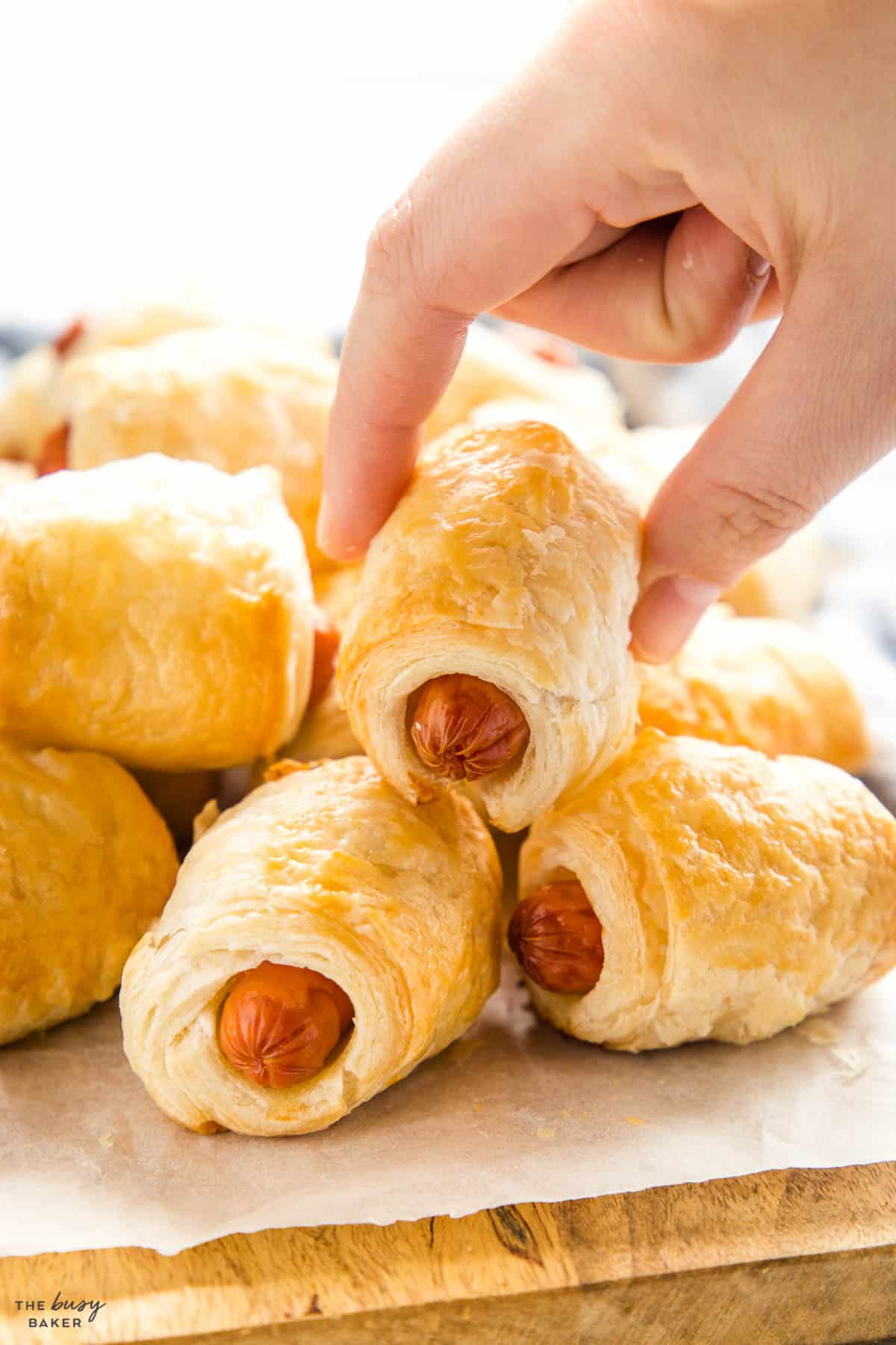 hand reaching for a homemade sausage roll