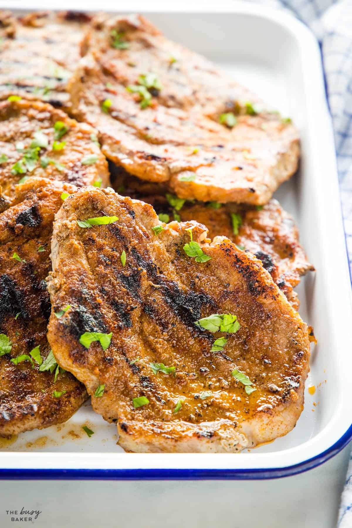 Boston Butt cutlet on a white tray with blue rim