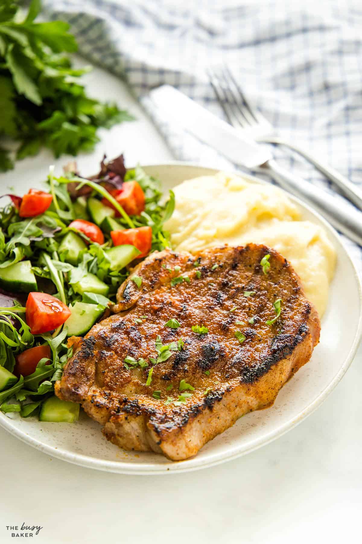 Boston butt steak on plate with mashed potatoes and salad