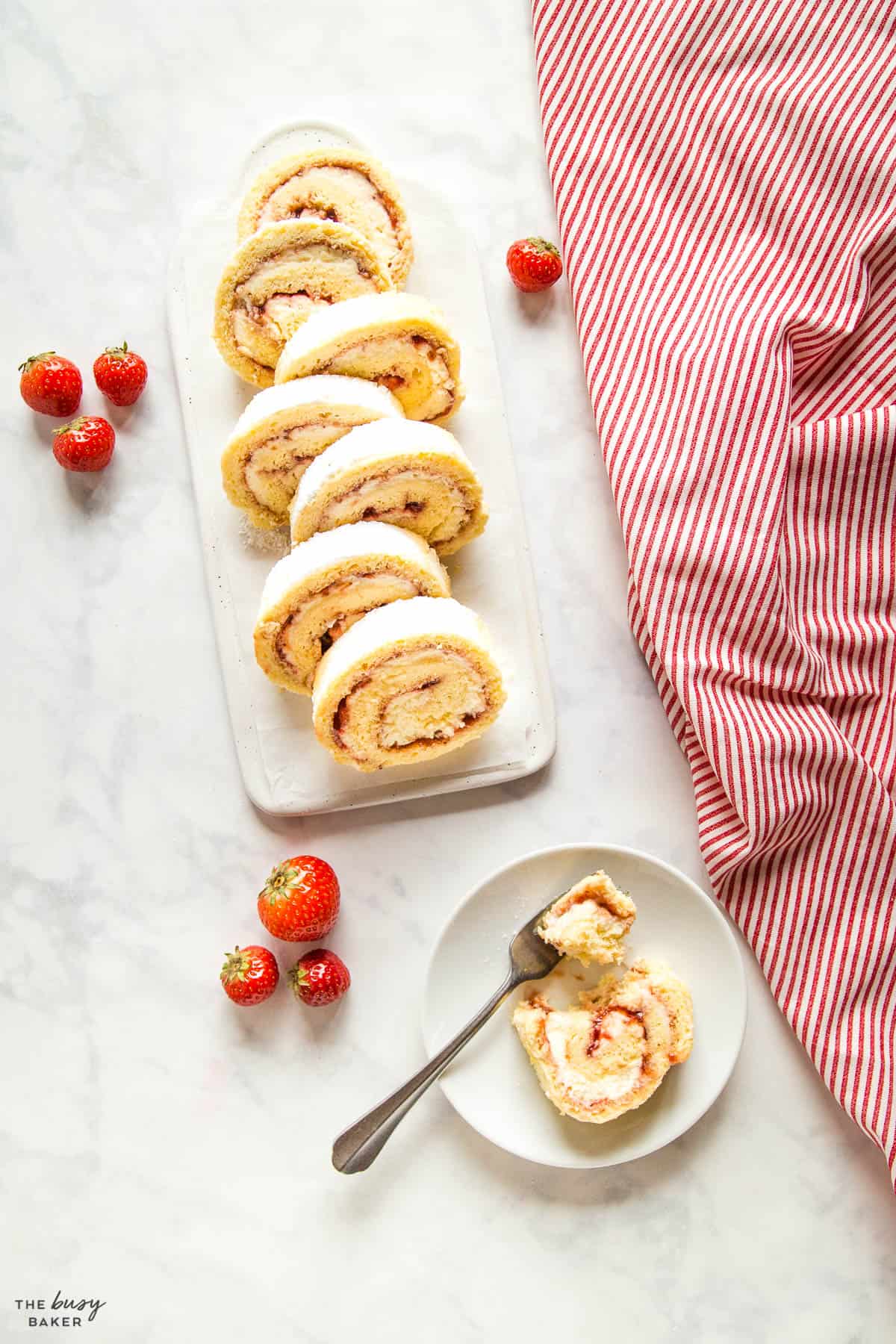 overhead image: swiss roll cake on white plate