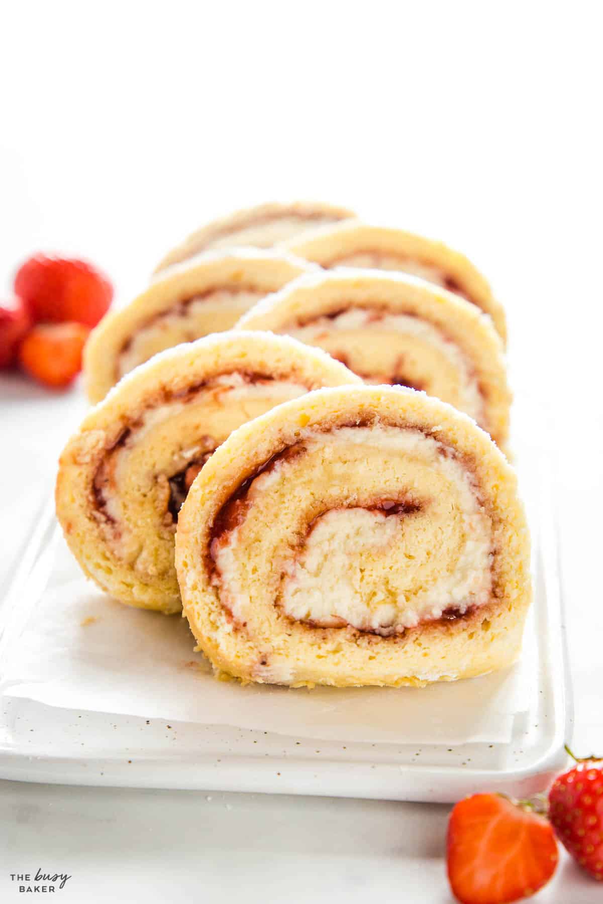 slices of rolled cake with strawberry jam and cream