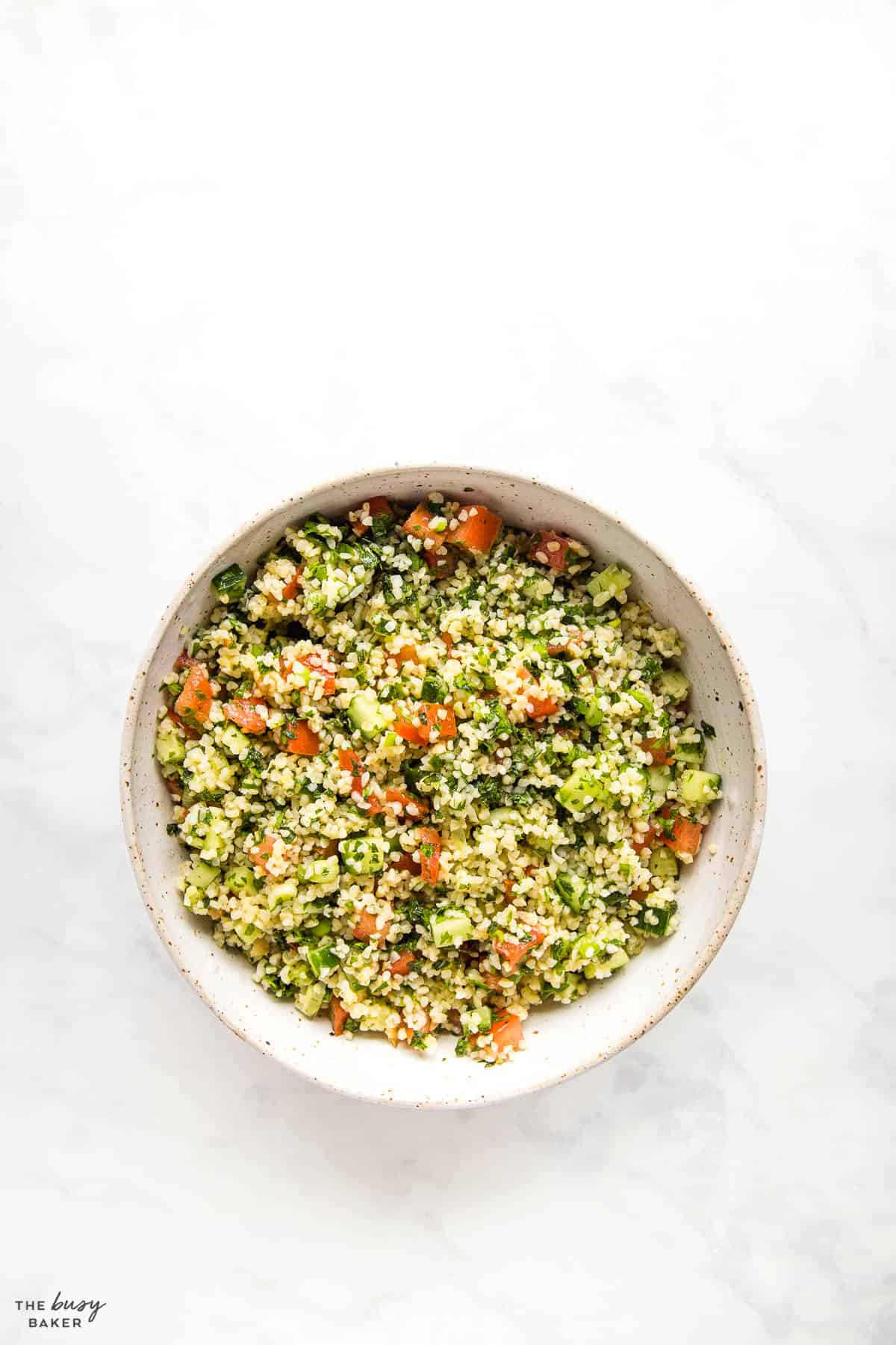 overhead image: Tabbouleh salad with fresh herbs and tomatoes