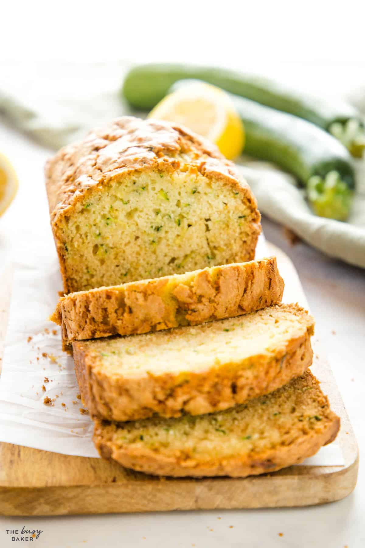 loaf of zucchini bread sliced on a cutting board