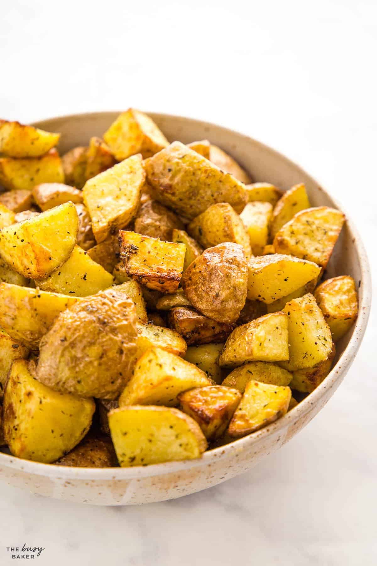 bowl of roasted potatoes with herbs and spices