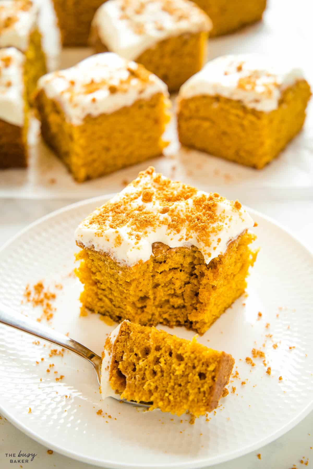 piece of pumpkin cake on a white plate with a fork