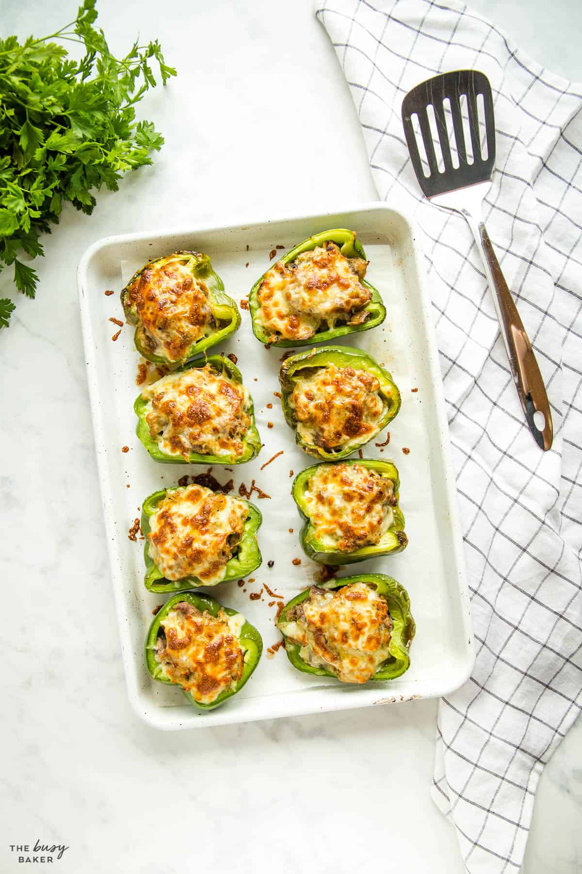 sheet pan of green peppers stuffed with steak, onions, mushrooms and cheese
