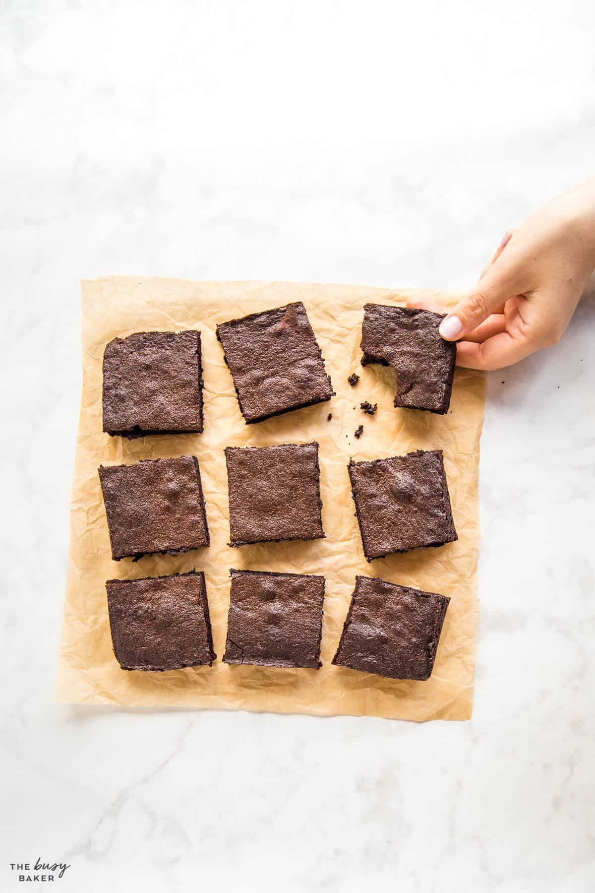 hand reaching for fudgy brownie