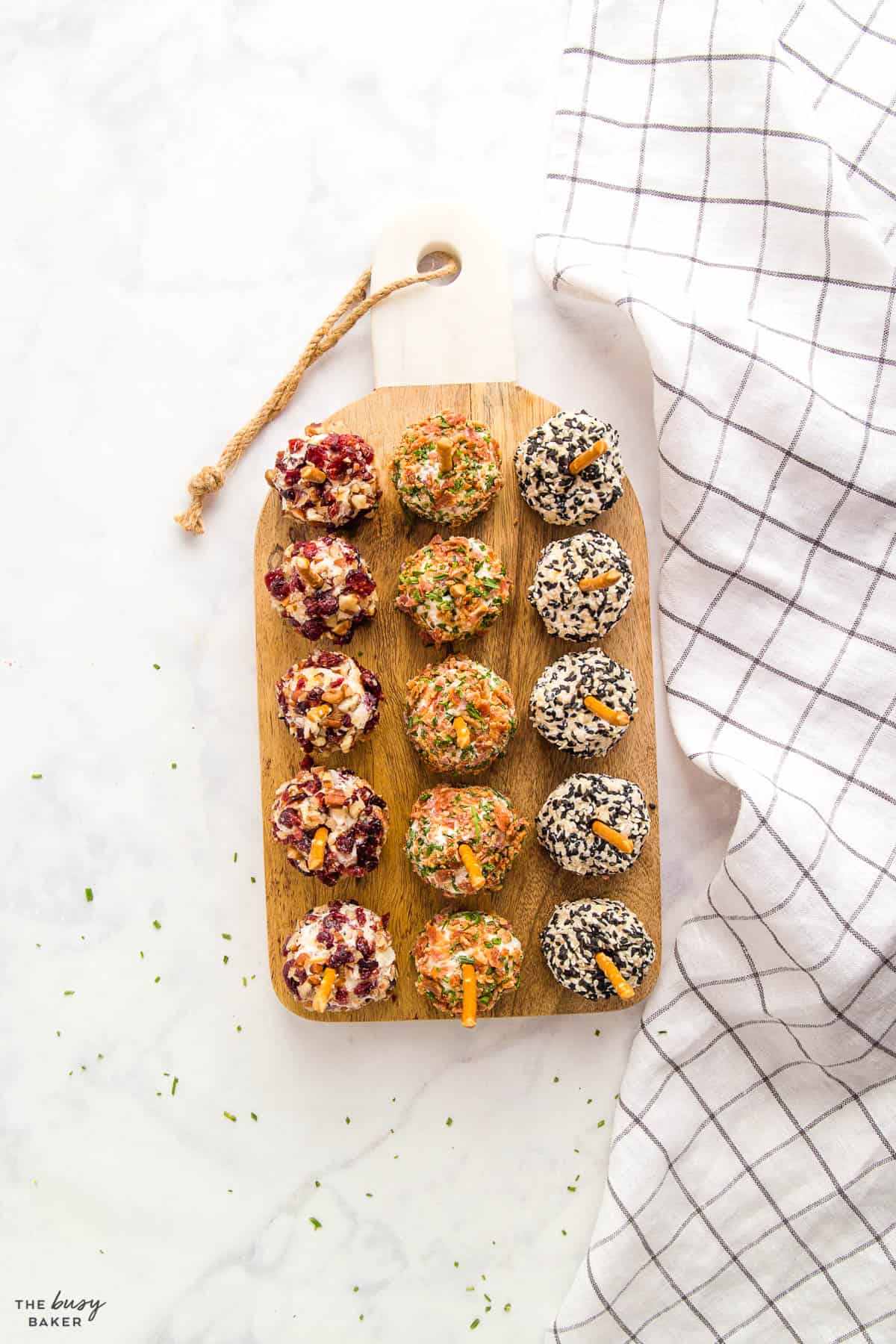 overhead image: mini cheese ball bites on wooden cheese board