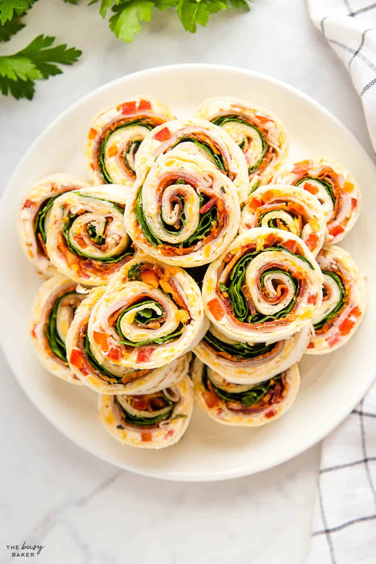 overhead image: pinwheels made with turkey, pepperoni, red pepper, cheese and spinach