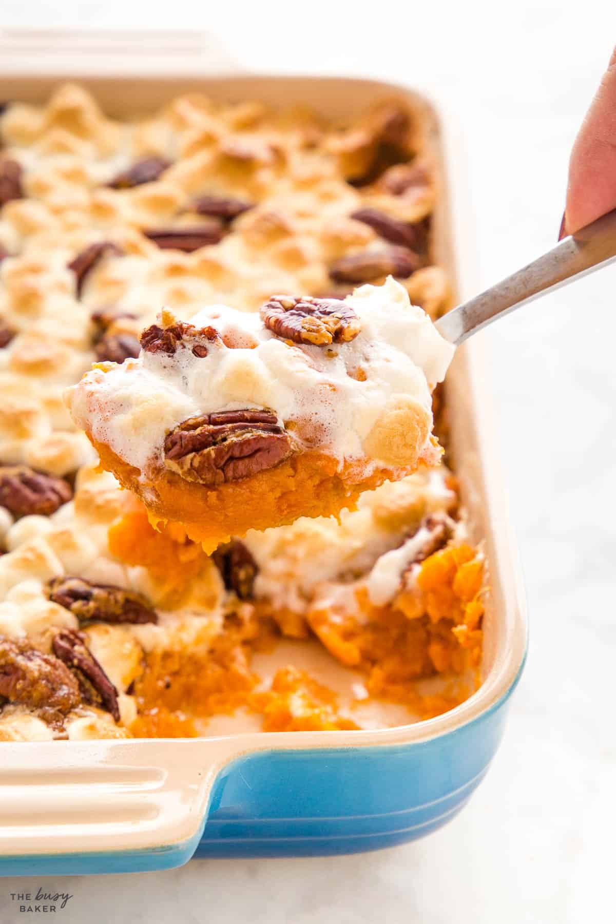 spoonful of sweet potato casserole with marshmallows and pecans
