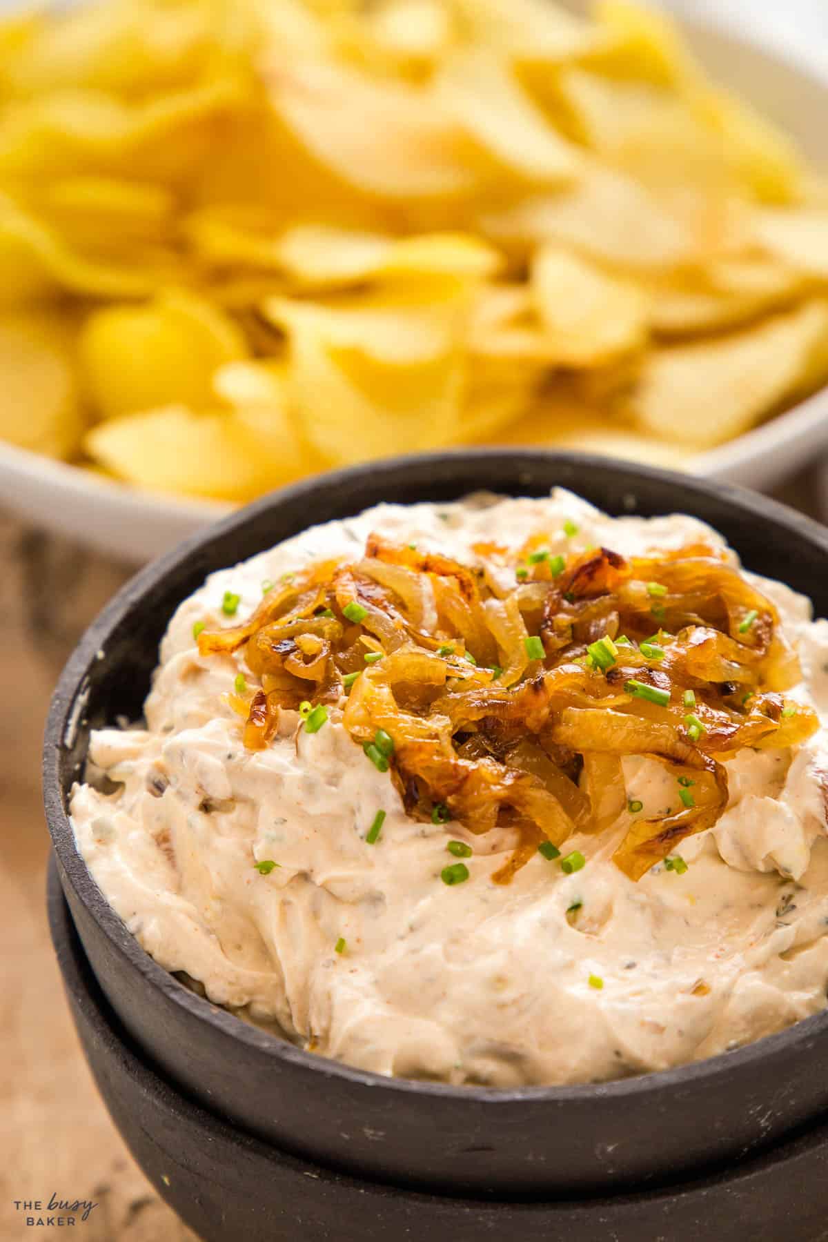 caramelized onion dip in a black bowl