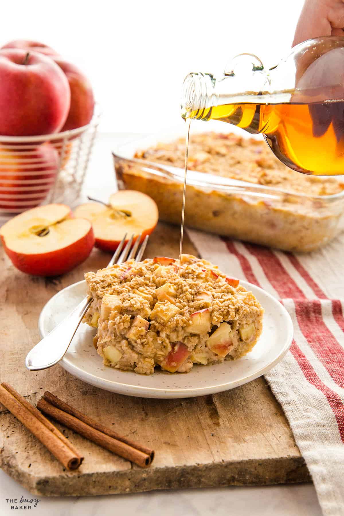 apple cinnamon baked oats on a plate with maple syrup