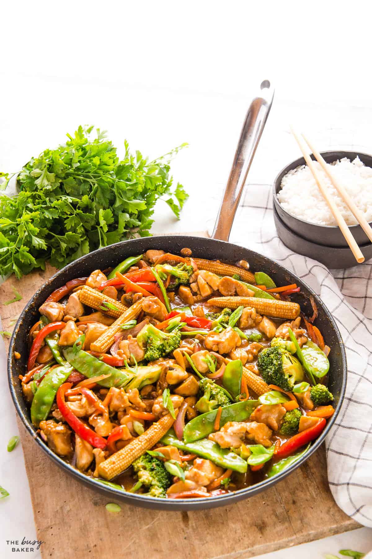 chicken stir fry in pan with veggies and sauce